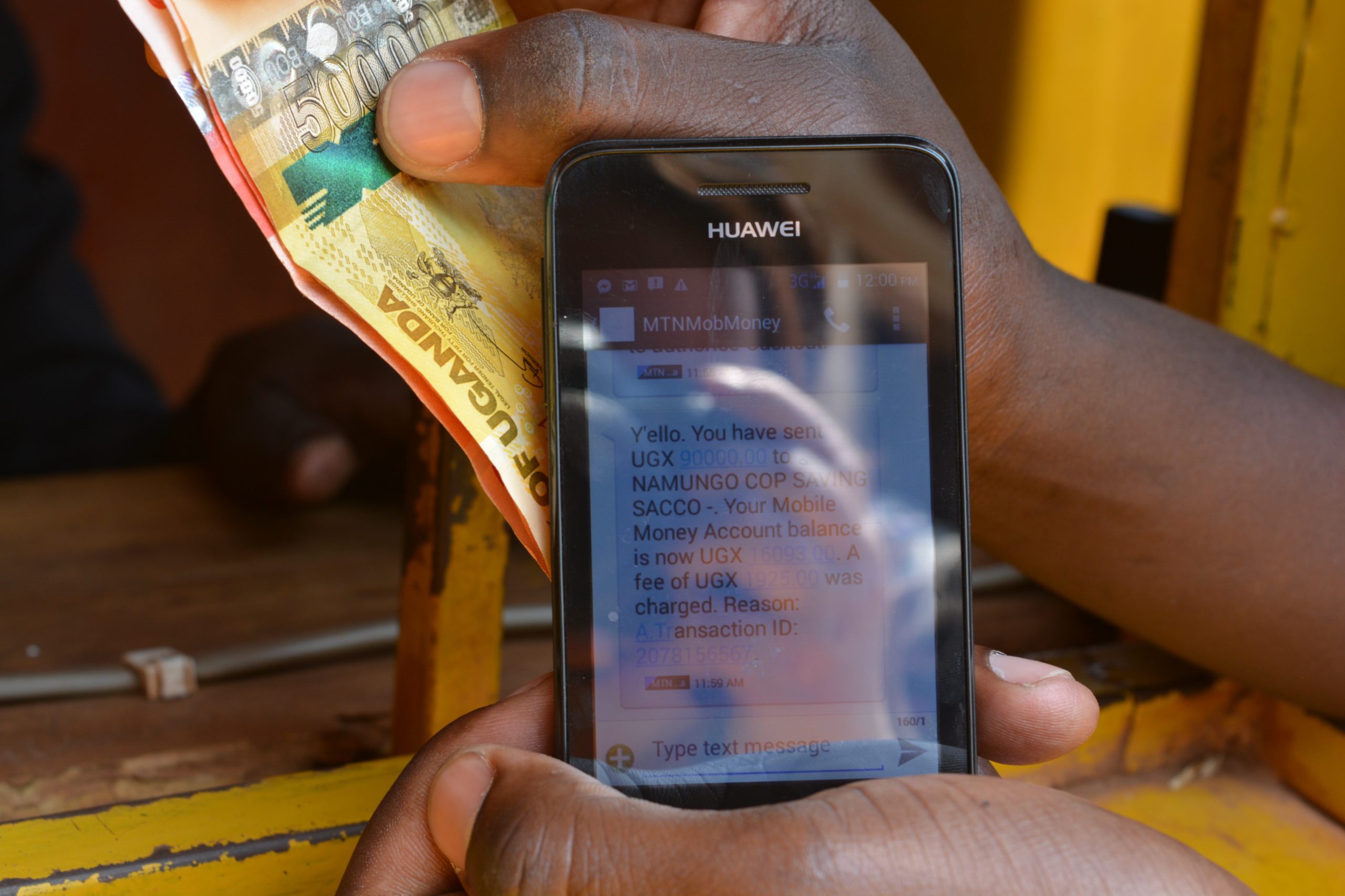 Man holding phone mobile money message
