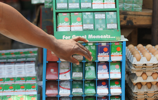 Hand reaching for a cigarettes pack