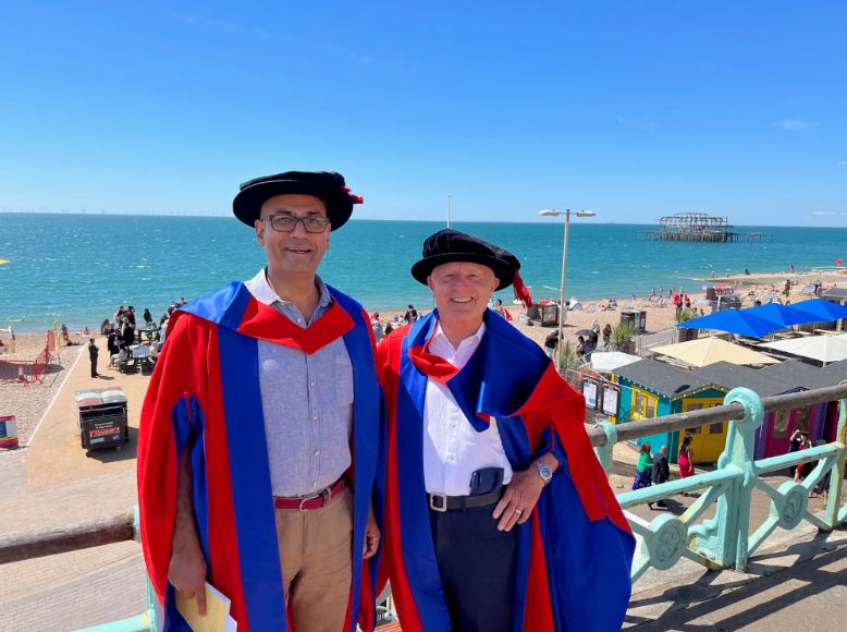 Mick and Mujtaba in their robes on the Brighton seafront
