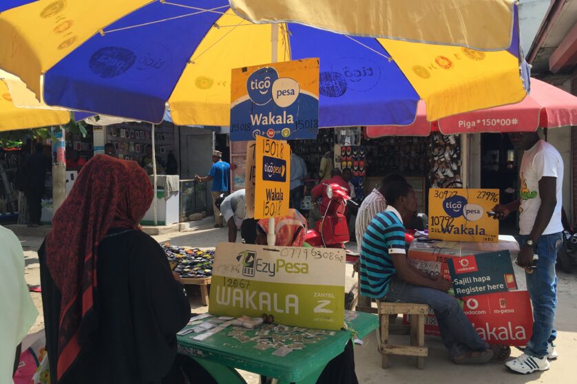 woman at a mobile money street stall in Tanzania
