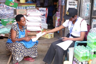 Tax official registers a female small business owner on the street