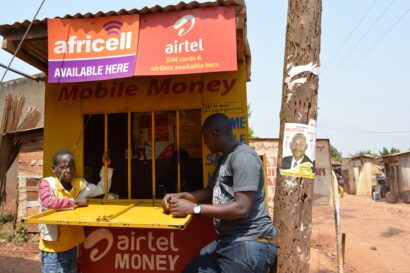 A man transacts at a mobile money kiosk in Uganda