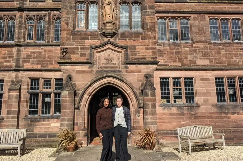 Adrienne Lees and Sripriya Srivatsa standing in front of the library