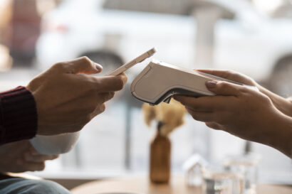 Person using nfc technology to pay the bill at a restaurant.