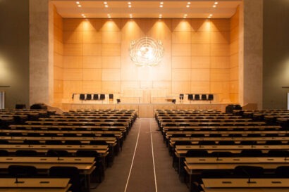 Wide shot from the back of an empty United Nations Assembly Hall