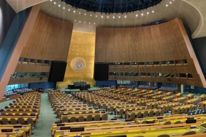 Large convening hall with the UN logo at the front