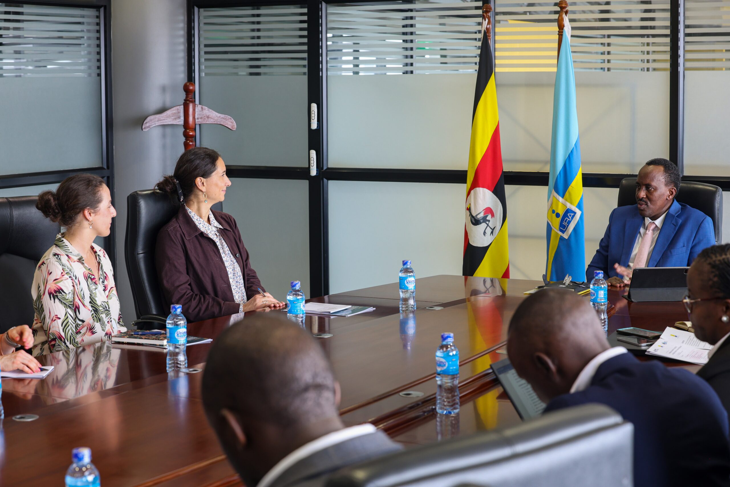 Giulia Mascagni and Adrienne Lees from ICTD is a meeting with URA Commissioner General John R. Musinguzi.