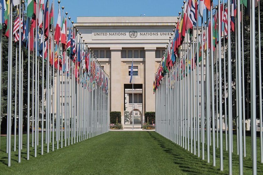 The UN headquarters in Geneva, Switzerland, flanked by a row of flags of different countries.