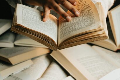 Woman Holding and Reading a Book