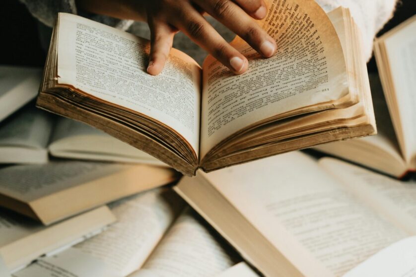 Woman Holding and Reading a Book