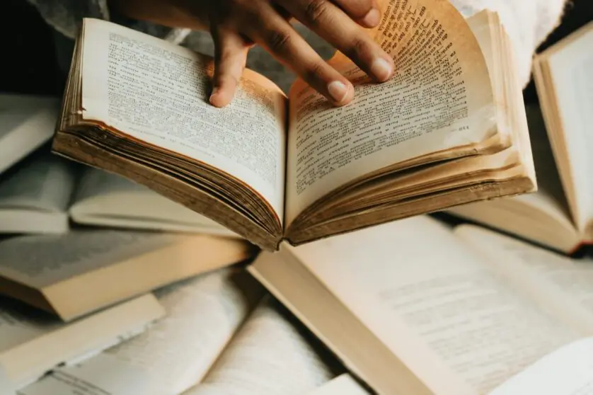 Woman Holding and Reading a Book