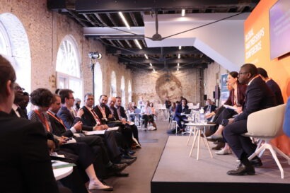 Side view of the stage with all speakers facing the audience at the FCDO Global Partnerships Conference